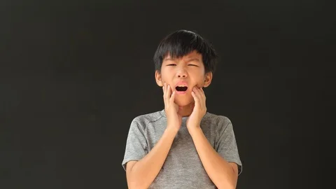 Young Asian boy has teethache Stock Footage 126977336