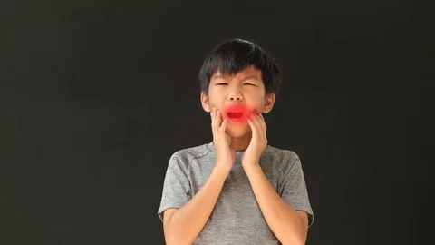 Young Asian boy has teethache with red animation zone Stock Footage 129553709