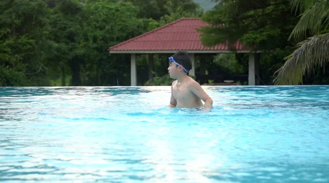 Young Asian boy having fun at pool, happy asian child playing in pool. Stock-Footage 68790886