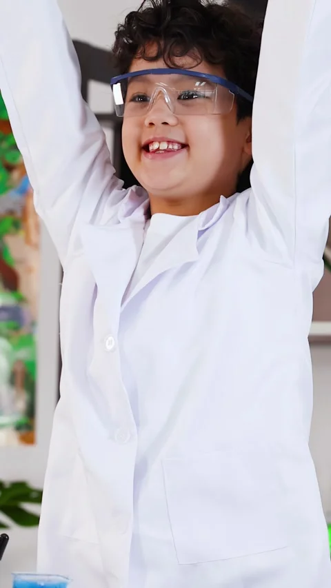 Young Asian Boy in Lab Coat Celebrating Successful Science Experiment 库存影片 333157510