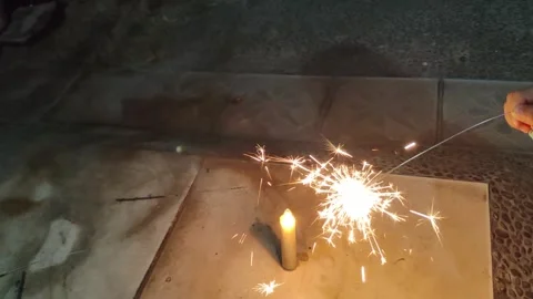 A young Asian boy lights a small firework Stock Footage 296929550