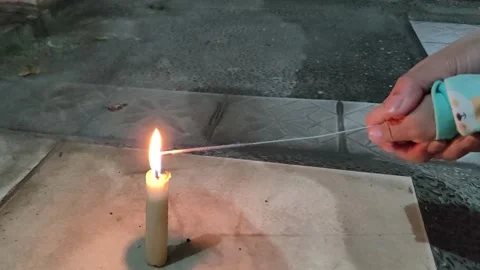 A young Asian boy lights a small firework Stock Footage 296929557