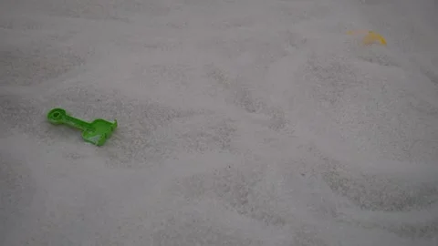 Young asian boy passing by in a playing pit filled with white sand Stock Footage 296891557