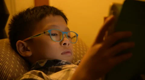 Young asian boy playing game on tablet computer Stock Footage 67302361