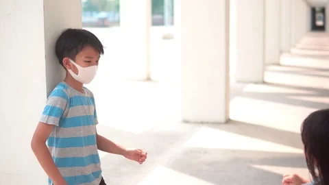 Young Asian boy put face mask to little girl Stock Footage 124367202
