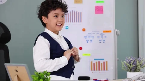 Young Asian Boy Putting On School Uniform Vest In Classroom Stock Footage 337009978