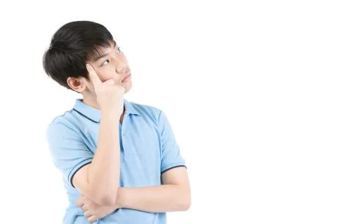 Young Asian boy thinking over white background Stock Photos