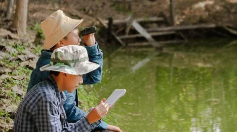 Young Asian boy is using a binocular to lookout for birds and animals Stock Photos