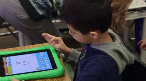 A young Asian boy using an iPad in school for learning. Stock Footage 57400598