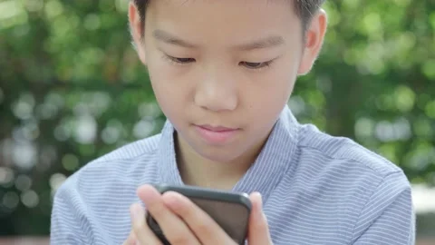 Young Asian boy using mobile phone 스톡 동영상 144854927