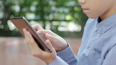 Young Asian boy using mobile phone Stock Footage 144855040