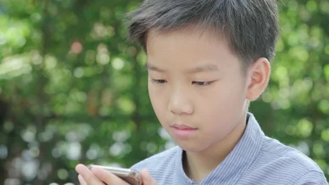 Young Asian boy using mobile phone 스톡 동영상 146295068