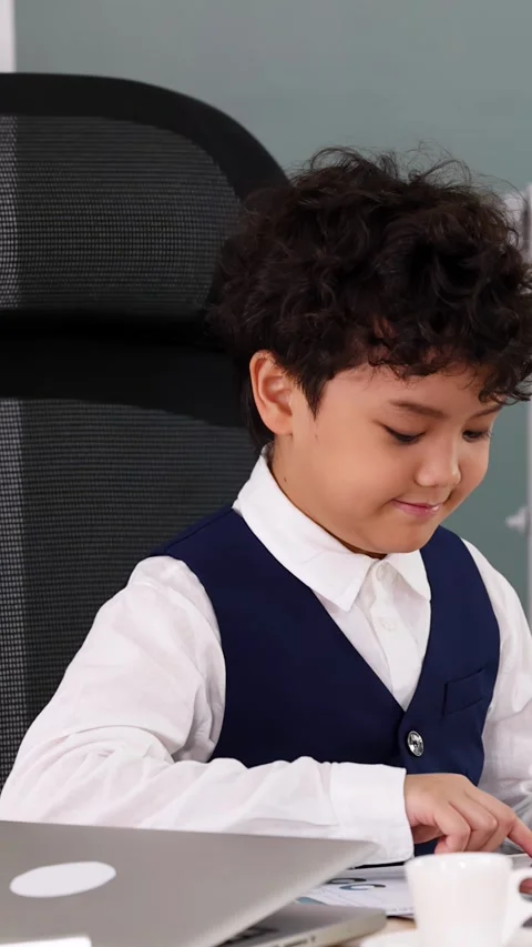 Young Asian Boy Using Tablet and Calculator in Modern Office Setting Stock Footage 338155581