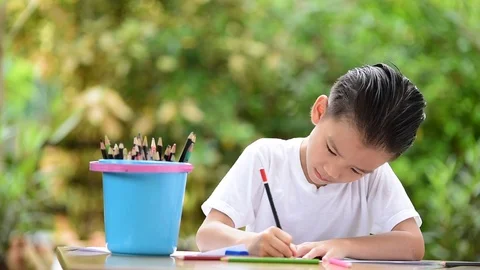 Young Asian boy write on the note book  Stock-Footage 72485266
