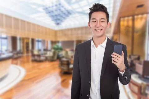 Young asian business man holding a cellphone Stock Photos