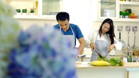 Young Asian couple enjoy to preparing Food in the Kitchen Stock Footage 77746191