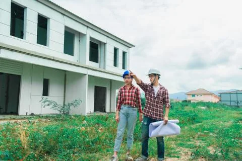 Young asian couple foreman engineering home inspection building house Walk ho Stock Photos