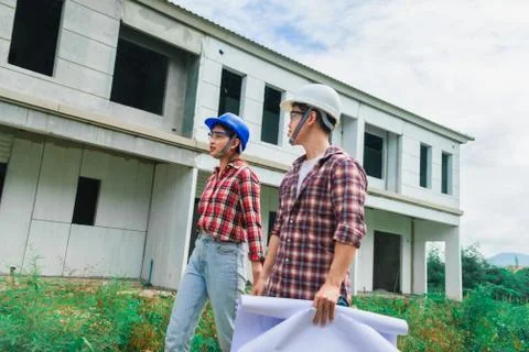Young asian couple foreman engineering home inspection building house Walk ho Stock Photos