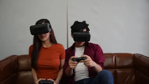 Young asian couple playing vr game in living room with scary action Stock Footage 123700272