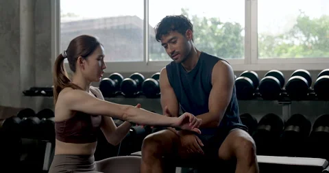 Young Asian couple practices partner training in modern gym, woman kneeling by Stock Footage 337812414
