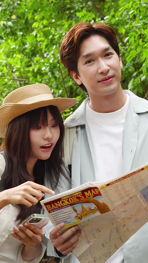 Young Asian Couple Reading Paper Map While Hiking Outdoors Stock Footage 346366273