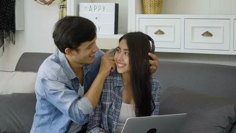 Young asian couple using labtop for shopping online. Sweet asian lovers spend we Stock Footage 87046251