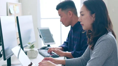 Young Asian developer programmer, software engineer, working with colleague Stock Footage 221106105