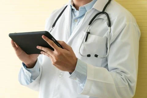 Young Asian doctors using tablets to check data and information for the healt Stock Photos