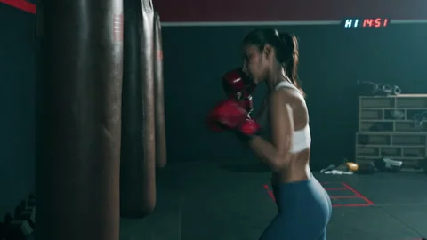 Young Asian doing boxing or Muay Thai punching sandbag in fitness club or gym Video stock 151607530