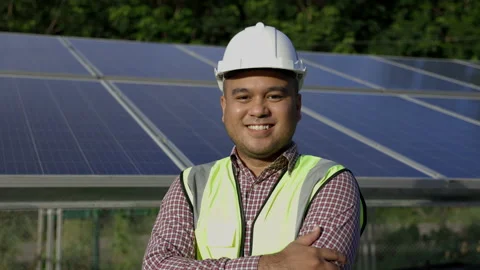  Young asian electrical engineer standing in front of Solar cell panels farm. He Video stock 158902560