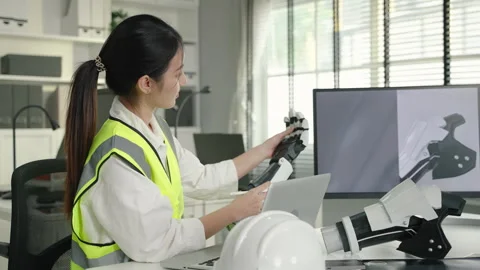 Young Asian engineer is designing a model of a robot arm to develop technology. Stock Footage 270411065