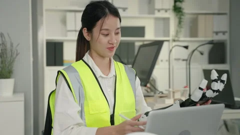 Young Asian engineer is designing a model of a robot arm to develop technology. Stock Footage 270411698