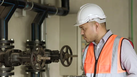 Young asian engineer working at valve water pump checking and maintenance. Stock Footage 162294085