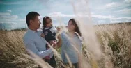 Young Asian Family In A Field With A Baby 1 Year On Hand, The Concept Of Marital Stock Footage