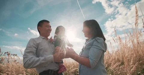 Young Asian family in a field with a baby 1 year on hand, the concept of marital Stock Footage