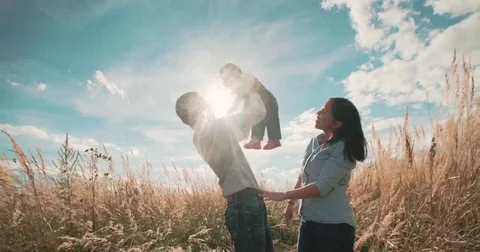 Young Asian family in a field with a baby 1 year on hand, the concept of family Stock Footage