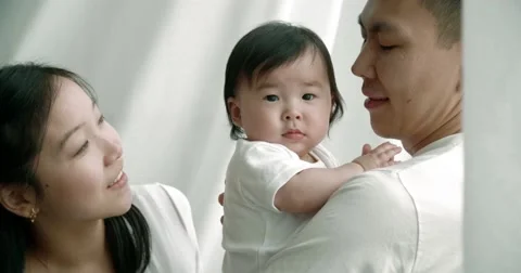 Young Asian family playing with 6 month old baby, slow motion Stock-Footage 59193269