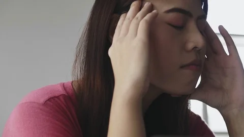 Young Asian female feeling stress from work in the office. Stock Footage