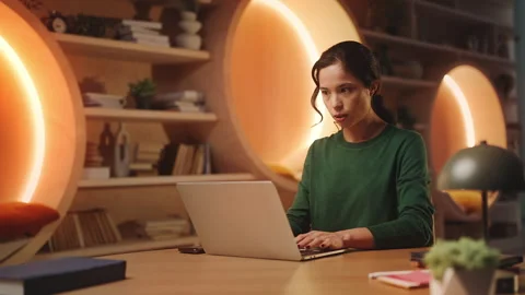 Young Asian game developer facing software bug while working in modern library Stock-Footage 340961278