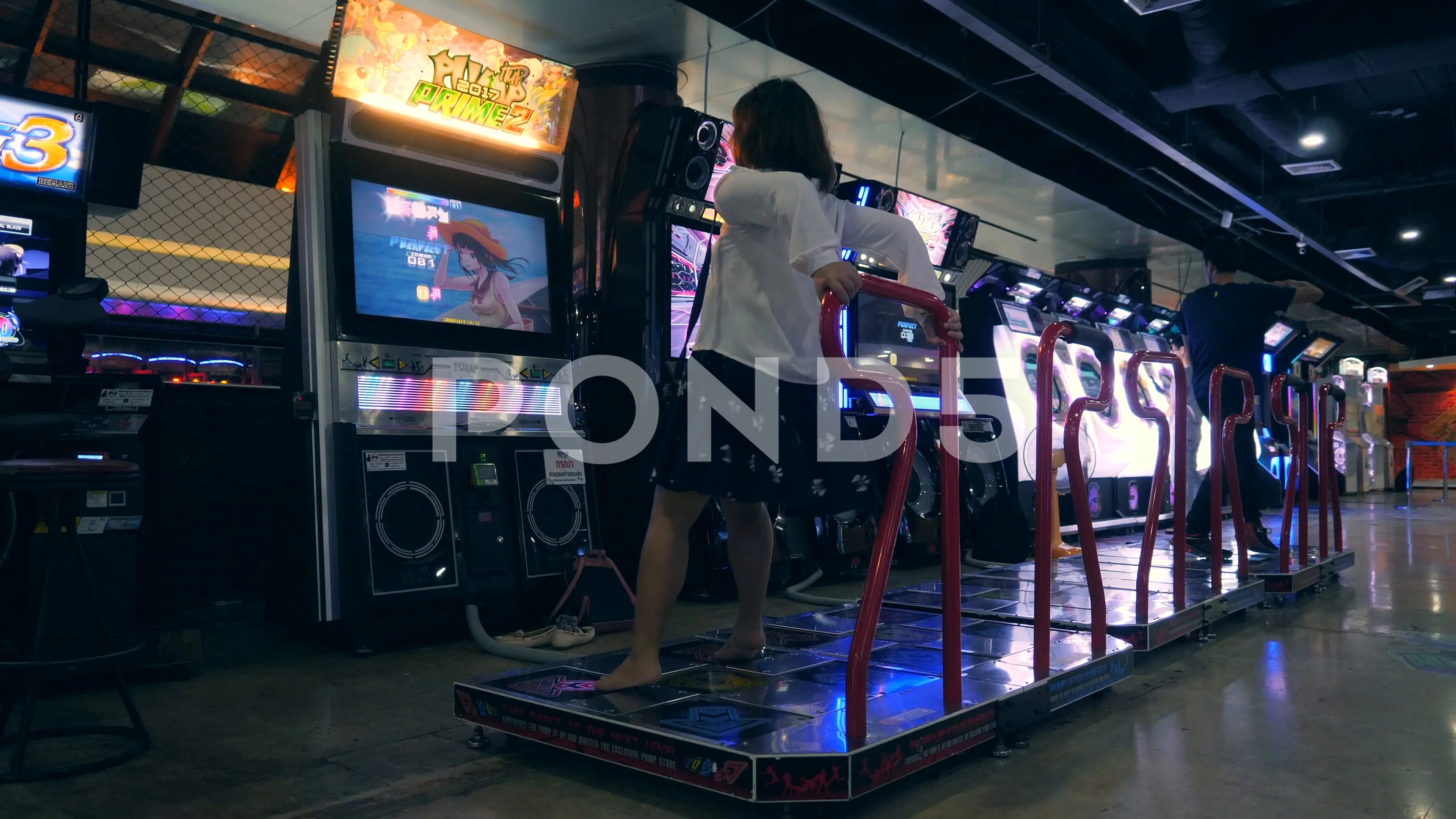 Young Asian Girl Dancing and Playing Dance Revolution Game on Arcade  Machine Pad