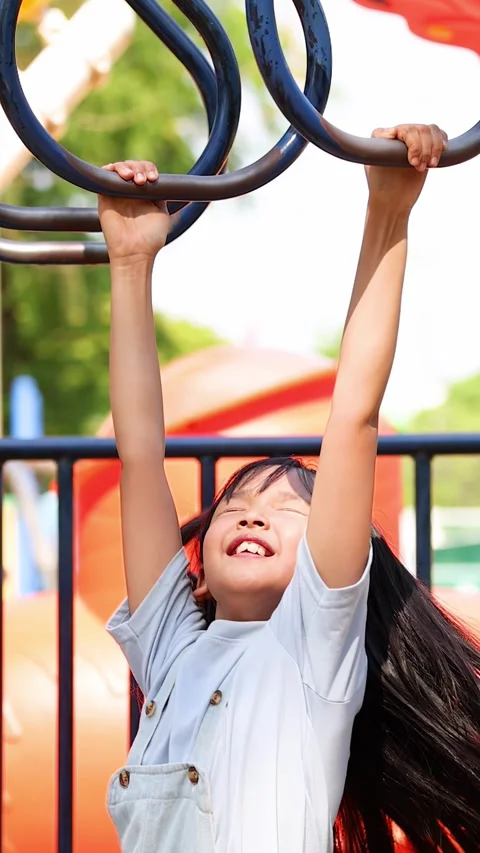 Young Asian Girl Playing on Monkey Bars at Outdoor Playground Stock Footage 335610189