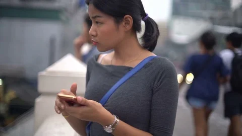 Young Asian Girl using smart phone on street 4k UHD (3840x2160) Stock Footage 81908456