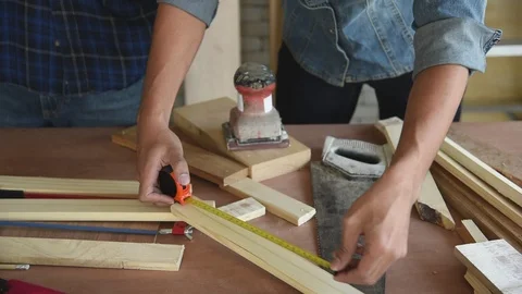 Young Asian group man worker measuring wood plank for build diy wood furniture Stock Footage 124103230