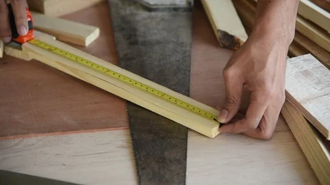 Young Asian group man worker measuring wood plank for build diy wood furniture Stock Footage 124105272