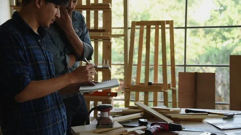 Young Asian group man worker discuss and planning about diy wood furniture Stock Footage 124106132