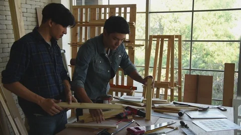 Young Asian group man worker discuss and planning about diy wood furniture Stock Footage 124107836