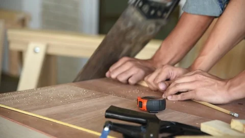 Young Asian group man worker cutting wood plank for build diy wood furniture Stock Footage 124183895