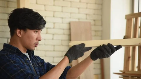 Young Asian group man worker blow sawdust Stock Footage 124887364