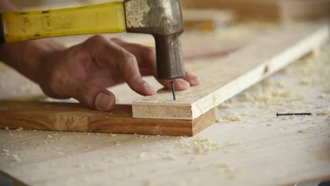 Young Asian group man worker using hammer to nail wood plank Stock Footage 124897403
