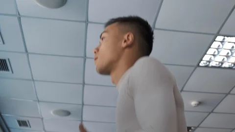 Young Asian guy is running on a treadmill in a gym. Stock Footage 114291050